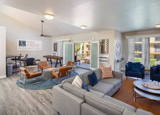 A living room with a grey couch and a coffee table.
