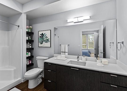 A bathroom with a white tub, sink, and toilet.