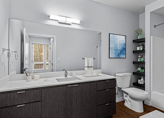 A bathroom with a white countertop and a large mirror.