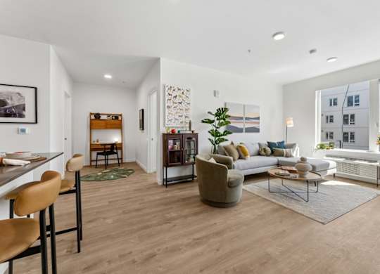 A modern living room with a wooden floor and furniture.