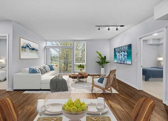 A dining room with a table set for two and a view of the backyard.