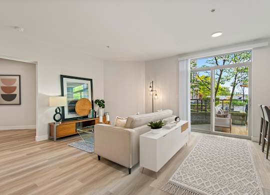 A modern living room with a white sofa and a wooden coffee table.