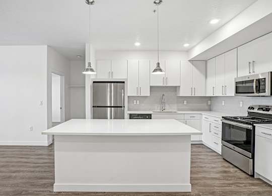 A modern kitchen with a large island in the center.