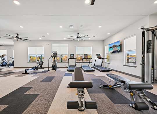 A spacious gym with a variety of exercise equipment.