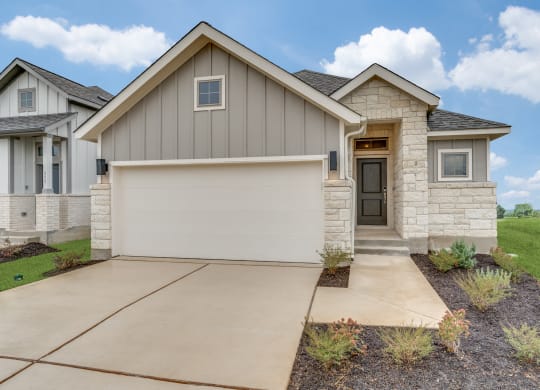 a house with a garage door in front of it