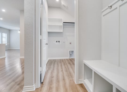the living room of a new home with white walls and wood floors