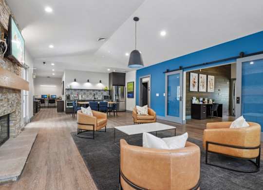 A modern living room with a stone fireplace and blue accent wall.