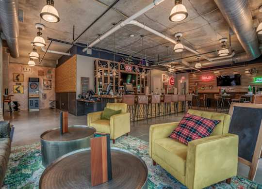 A room with a yellow chair and a wooden table.