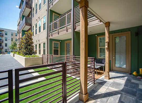 A balcony with a railing and a bench is shown.