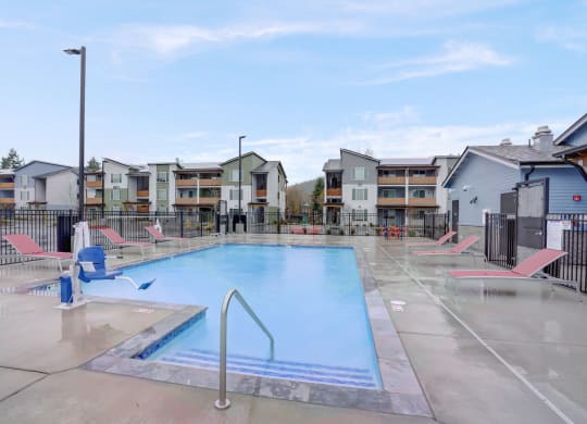 the pool at the preserve at polk apartments with chairs around it