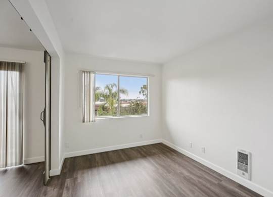 A room with a window and a door.