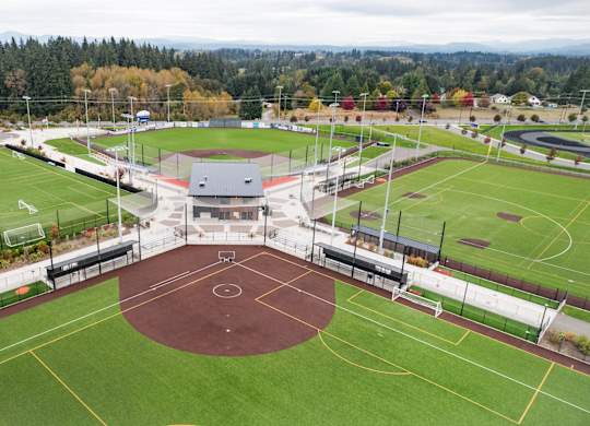 A sports complex with a basketball court in the center.