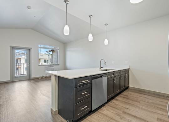 A modern kitchen with a white countertop and black cabinets.