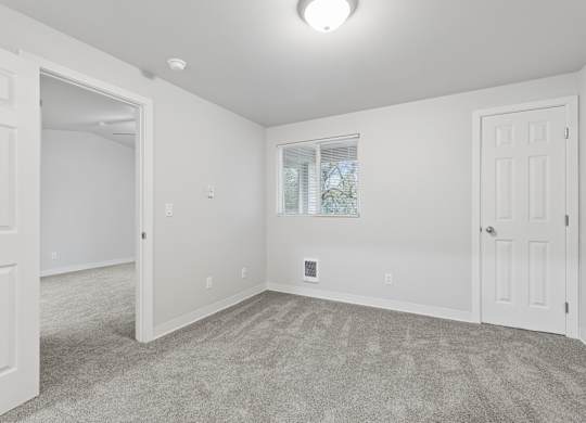 A room with white walls and a carpeted floor.
