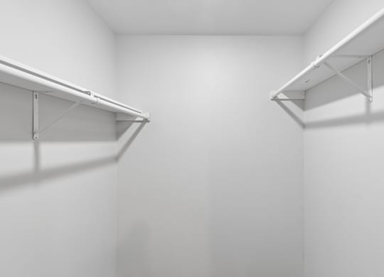 Two white shelves in a white room.