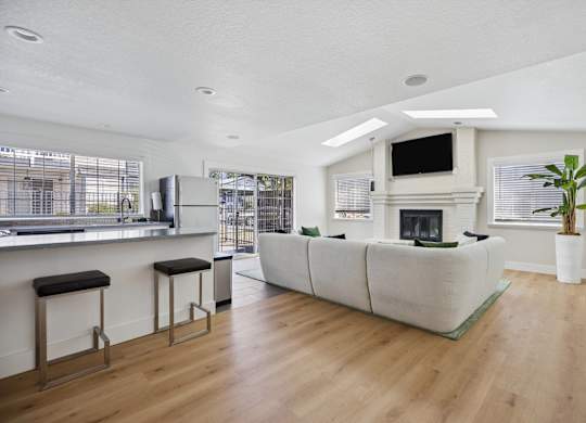 A modern living room with a fireplace and a bar area.
