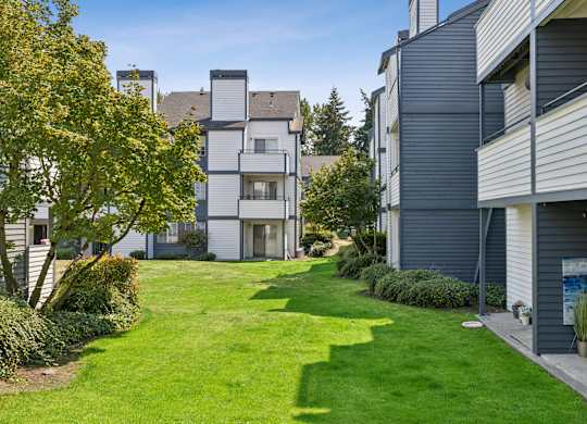 A well-maintained lawn leads to a modern two-story building.