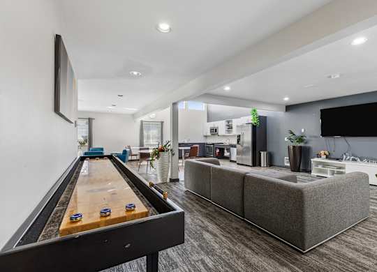 A room with a pool table and a couch.