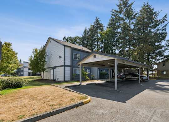 A carport is attached to a modern house.