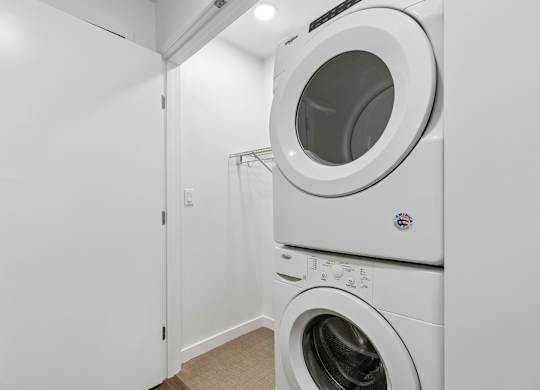 A white washing machine and dryer in a laundry room.