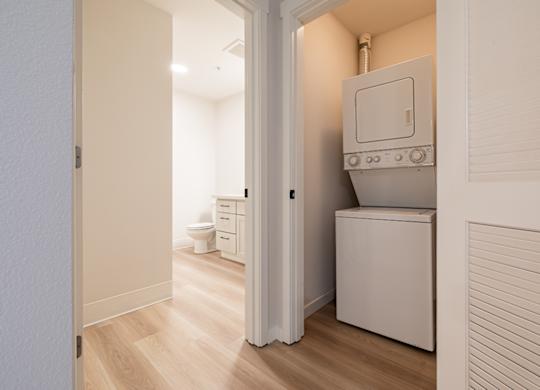 A small white laundry room with a washer and dryer.