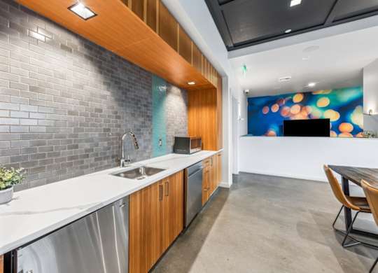 Modern entertaining kitchen in community lounge at Grand Belmont Apartments in Central Eastside Portland, Oregon.