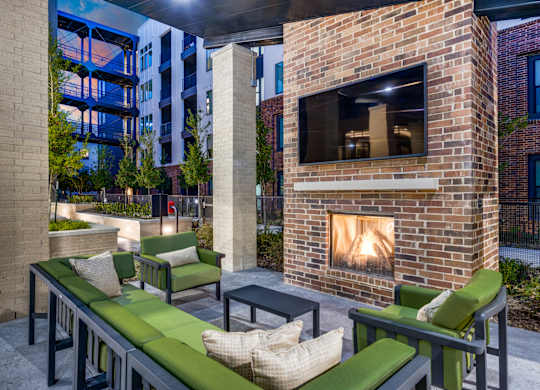 A patio with a fireplace and seating area.
