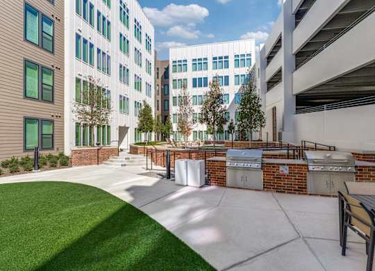 A courtyard with a bench and a brick wall.
