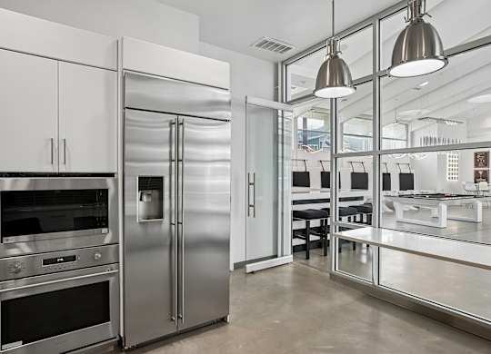 A modern kitchen with stainless steel appliances and white cabinetry.