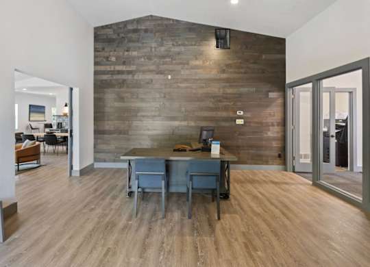 A room with a wooden table and chairs.