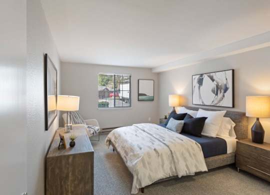 A bedroom with a large bed and a window.