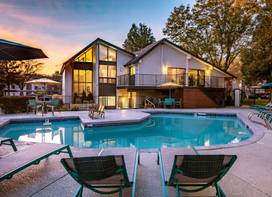 Clover Creek Apartments Pool Area and Lounge Chairs at Dusk