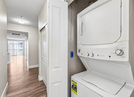 A white oven in a kitchen with a window in the background.