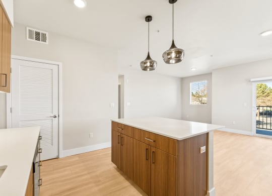 a white kitchen with wooden cabinets and a white counter top