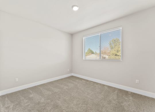 an empty room with a window and a mural on the wall