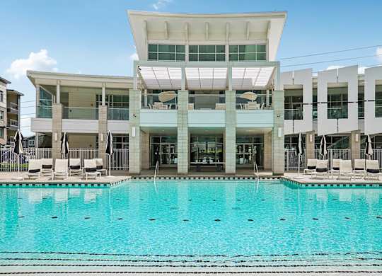 A large swimming pool in front of a modern building.