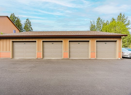 A two-car garage with a brown roof and tan walls.