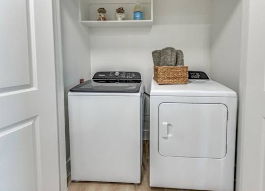 A small laundry room with a washer and dryer.