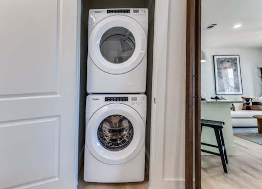 A white front loading washing machine in a modern home.