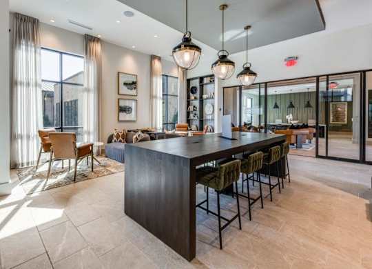 A modern kitchen with a bar area and a dining table.