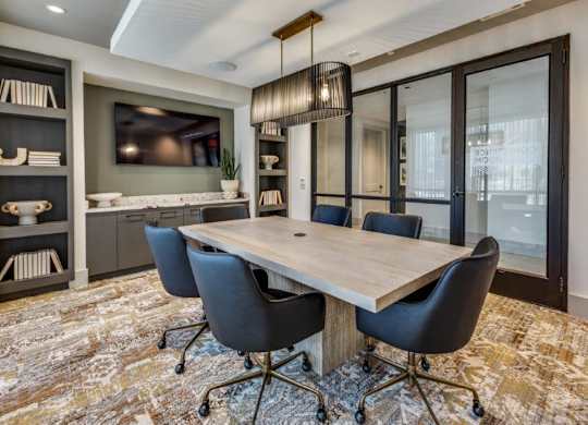 A modern dining room with a wooden table and chairs.