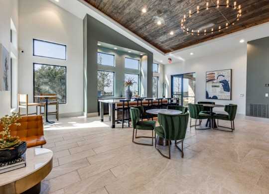 A modern dining room with a wooden ceiling and a large table surrounded by chairs.