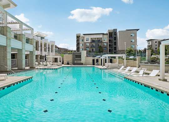 A large swimming pool in front of a building.