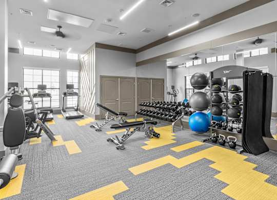 a gym with weights and cardio equipment and a punching bag at Alton Jefferson Park, Denver, CO