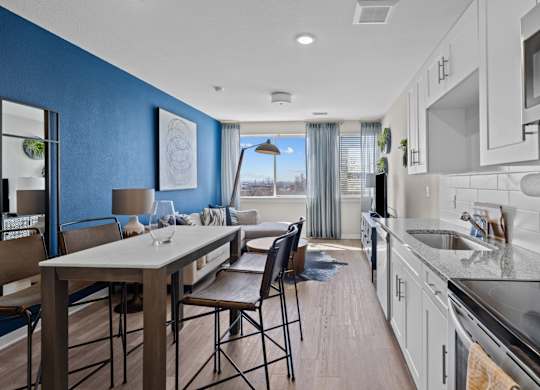 a kitchen and living room with blue walls and white cabinets at Alton Jefferson Park, Denver, 80211