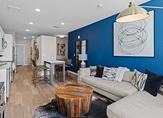 a living room with a blue wall and a couch and a table at Alton Jefferson Park, Denver, CO