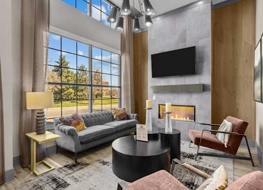 a living room with couches and a fireplace and a large window at Alton Jefferson Park, Denver, CO 80211