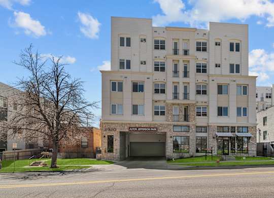an apartment building with a garage on a city street at Alton Jefferson Park, Denver, CO