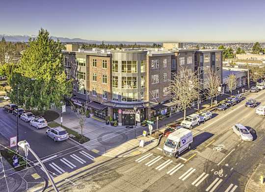 A street view of a city with cars, trucks, and a bus on the road.