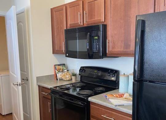 A black microwave oven is on the counter.